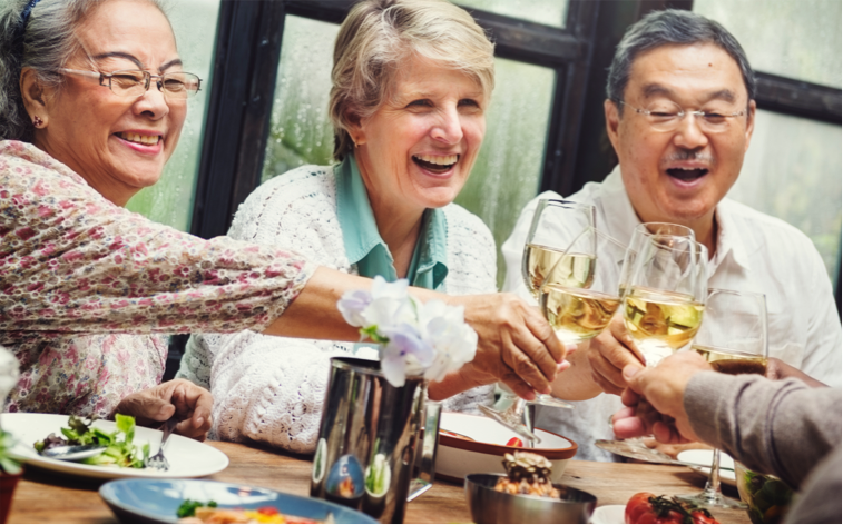 seniors-dining Seniors enjoying a meal together, raising glasses in a toast and smiling