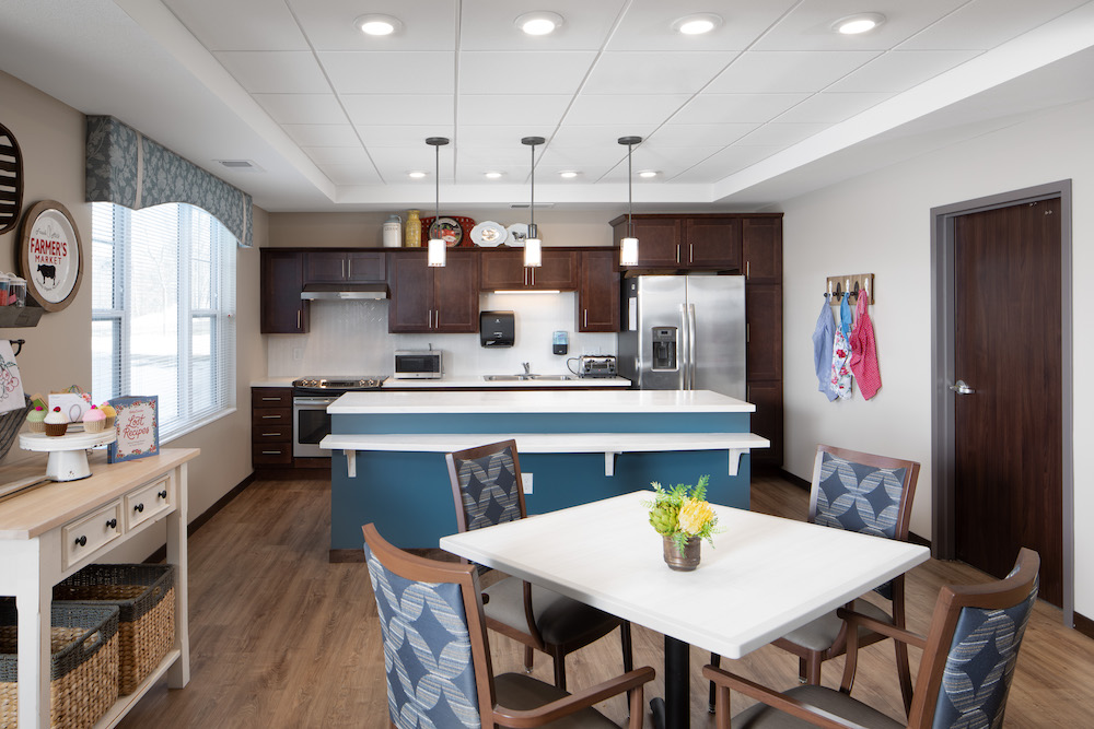 Modern kitchen with stainless steel appliances, island, and adjacent dining area