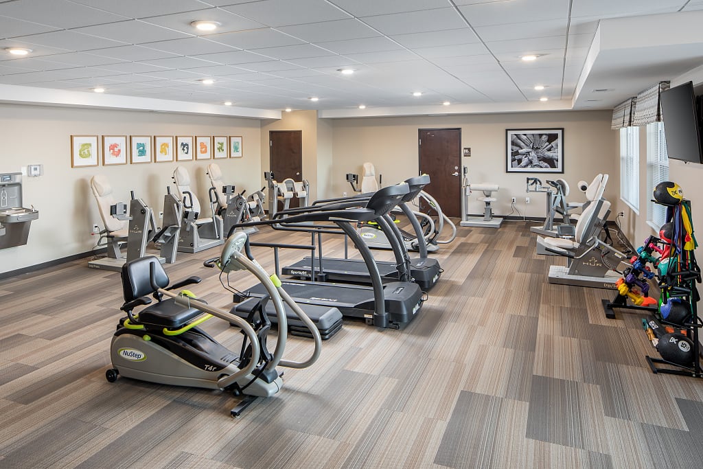 Fitness center with various exercise machines and weights.