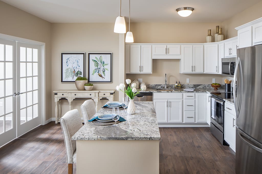 Modern kitchen with white cabinets and a kitchen island with barstools.